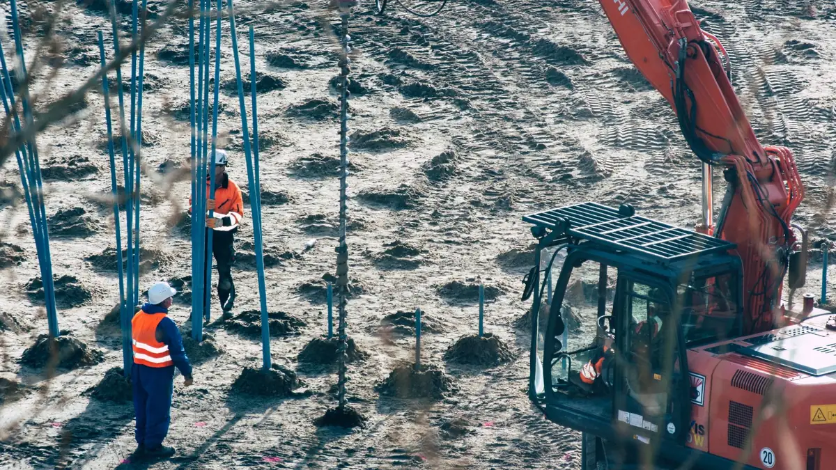 Helical pier being driven into the ground for foundation underpinning in Henderson, NV